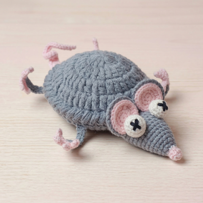 Crocheted mouse toy on a beige background